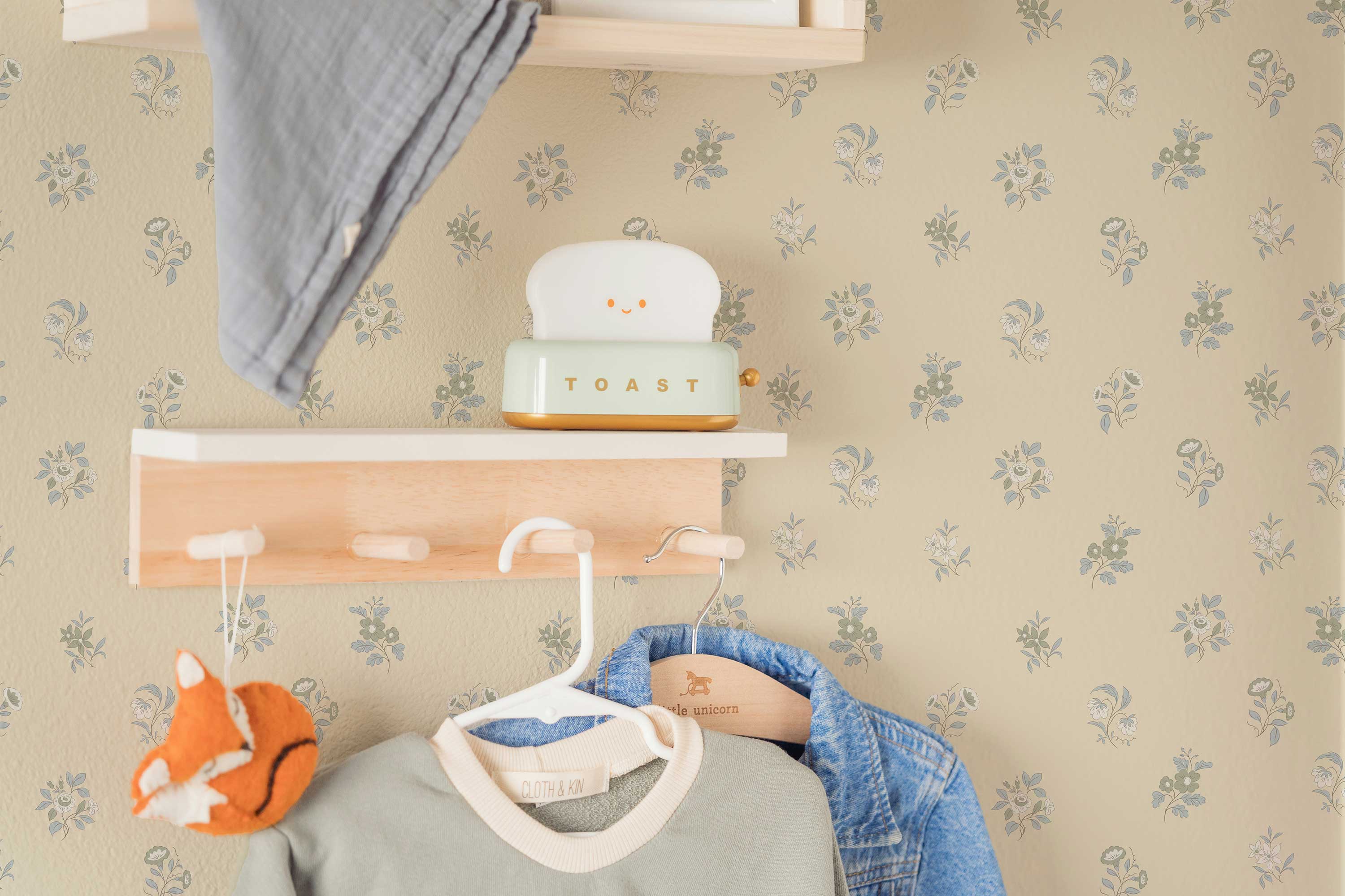 Children's room with shelves, toys, and patterned wallpaper