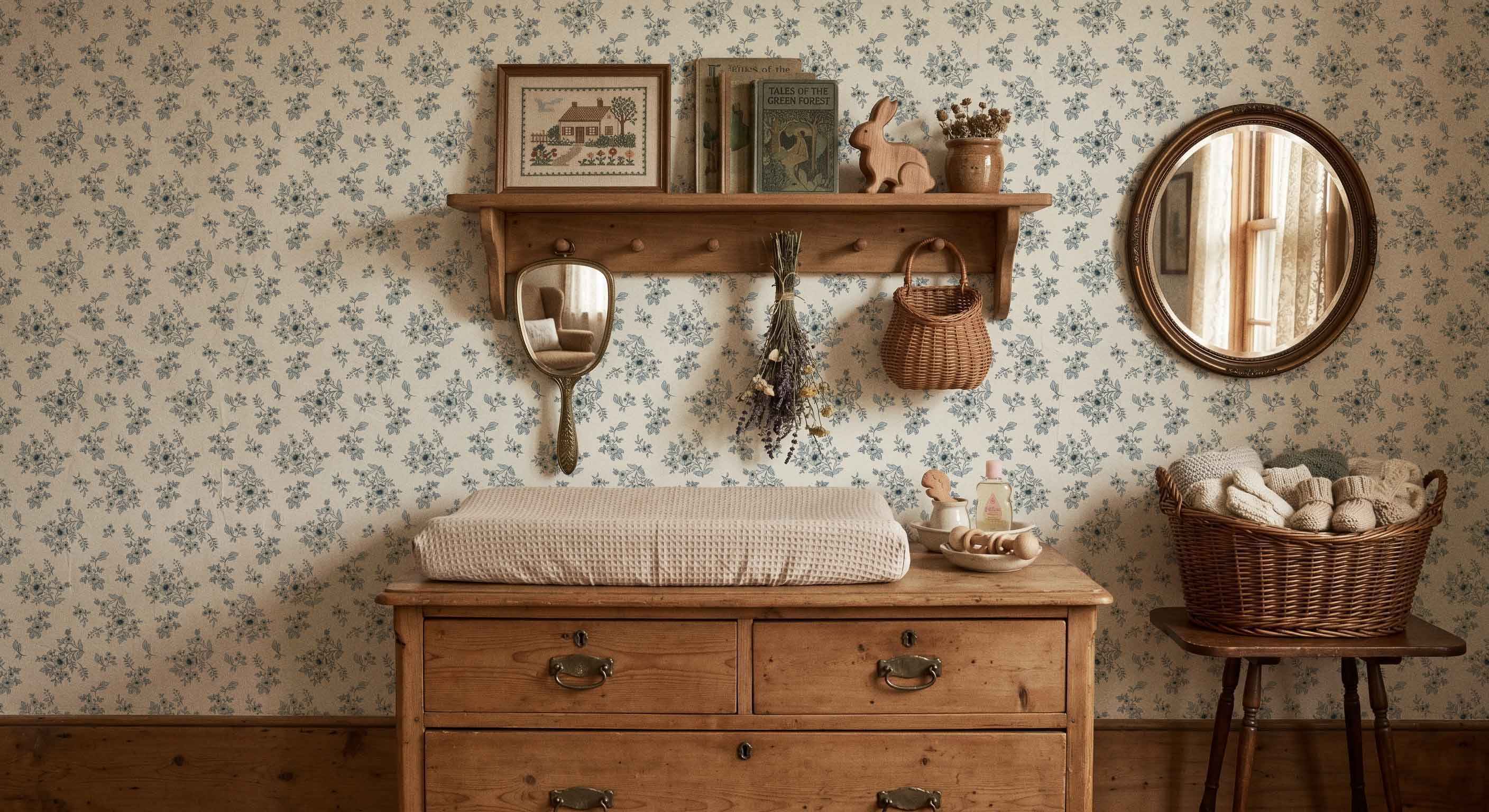 Nursery room with wooden dresser, shelves, and decorative items against floral wallpaper.