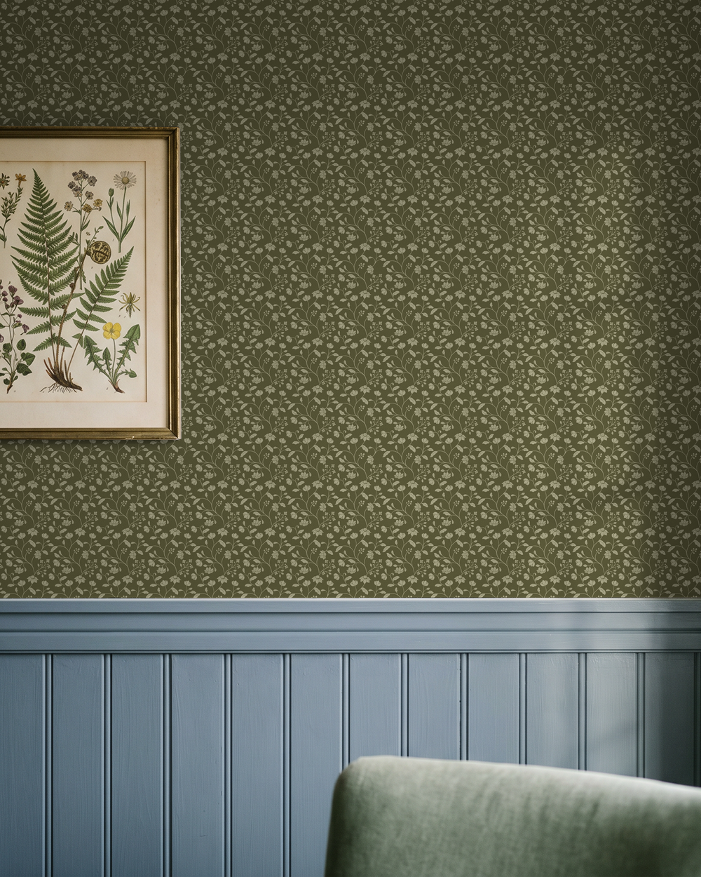Wild Geranium wallpaper in earthy olive with floral motifs in a vintage living room setting.